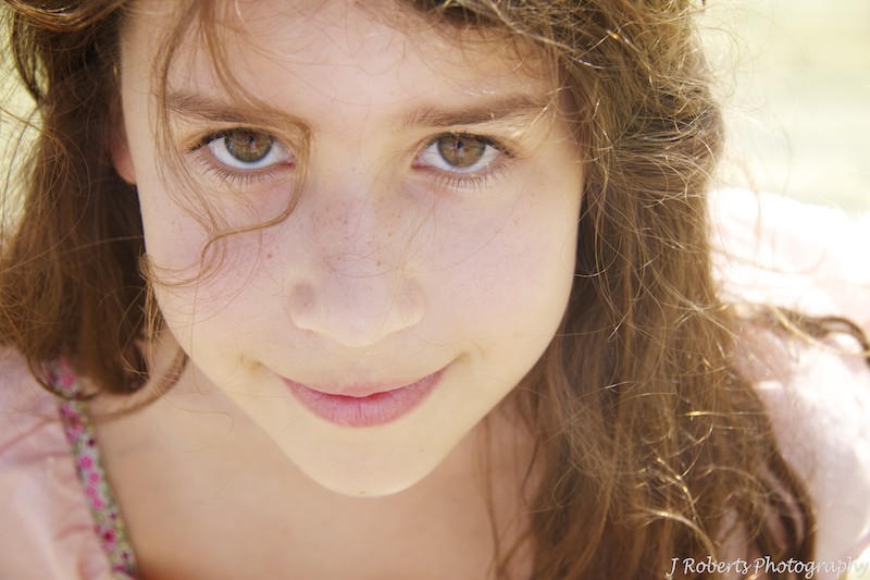 Beautiful eyes of child looking at camera - family portrait photography